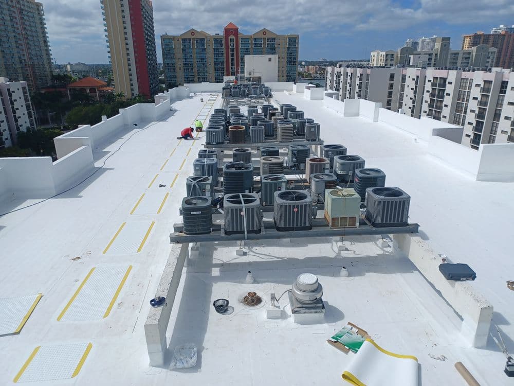 Rooftop HVAC units with city skyline in the background, showcasing cooling equipment layout.